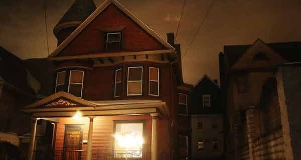 Victorian haunted house at night — original featured image for Tim Wood's haunted real estate article