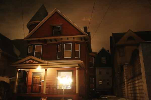 Victorian haunted house at night — original Haunted Real Estate article photograph