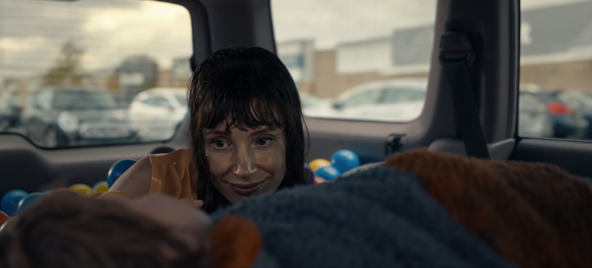 Other Mommy movie scene showing Jessica Chastain in a deceptively reassuring maternal pose