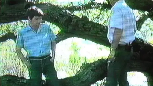 Archival still showing two figures outdoors, reproduced from the original Waterdog Lake article