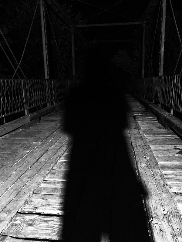 Old Alton Bridge and its wooded surroundings at night
