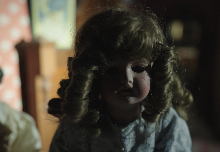 Close-up of an antique porcelain doll displayed in Mackay Mansion