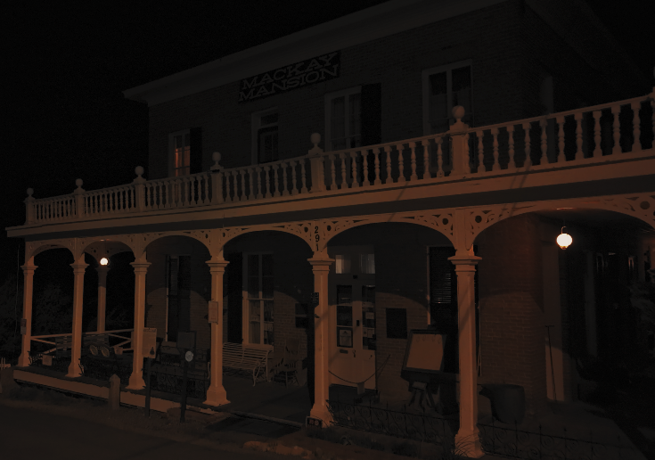 Historic exterior of Mackay Mansion at night in Virginia City, Nevada