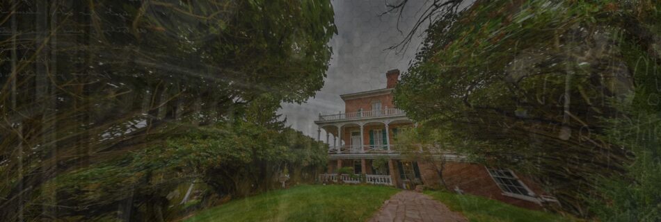 Historic Mackay Mansion exterior in Virginia City, Nevada, surrounded by trees