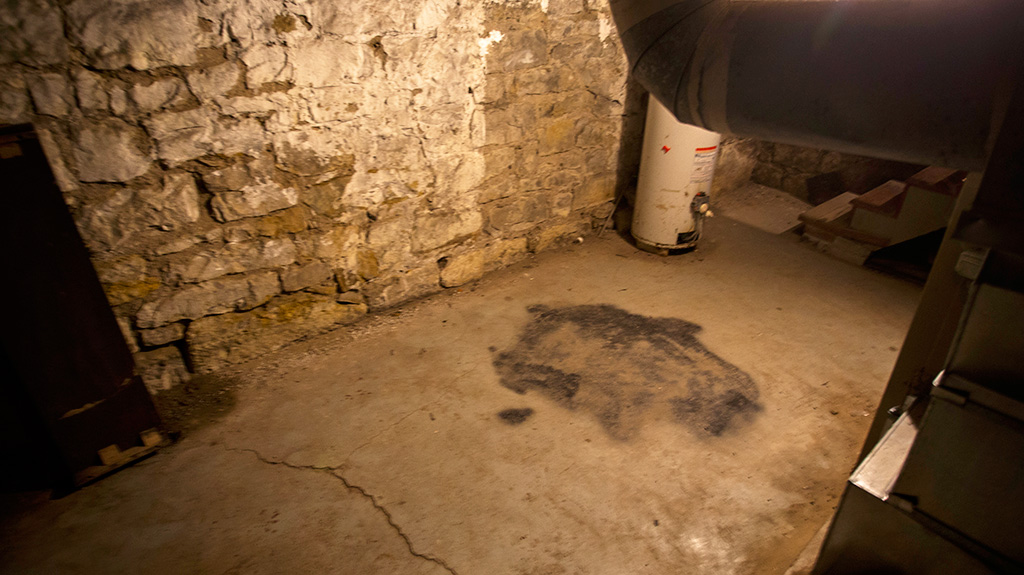 Sallie House basement floor with darkened marks where Tim Wood reports the former pentagram was painted over