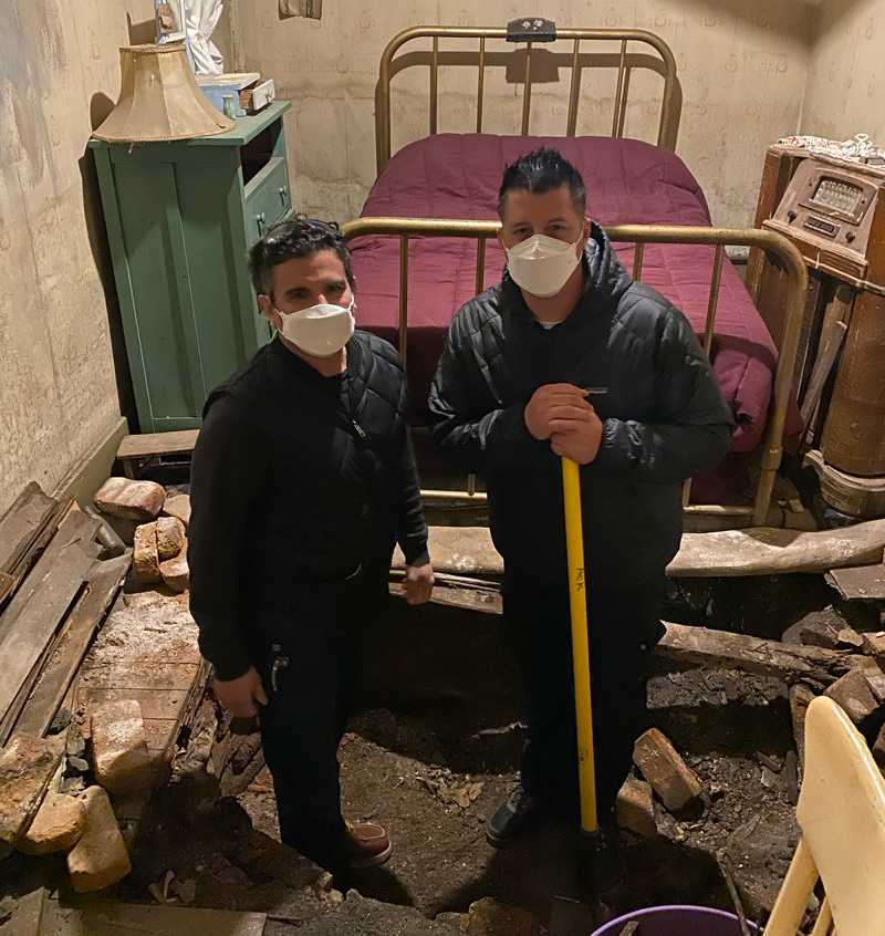 Tim Wood and Scott Di Lalla examining bone-like fragments in the Dumas Brothel basement