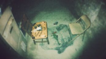 Basement ghost hunt setup with Ouija board, chairs and investigation equipment photographed during a LiveSciFi investigation
